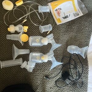 Medela Breast Pump with Black Case and Yellow Controls